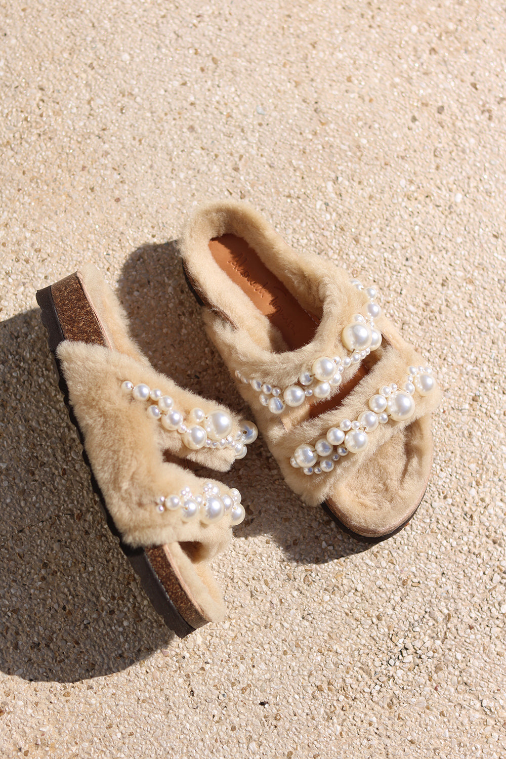 Alameda Turquesa Mimi Pearls shearling sandals with pearl embellishments, flat lay — as seen in Emily in Paris