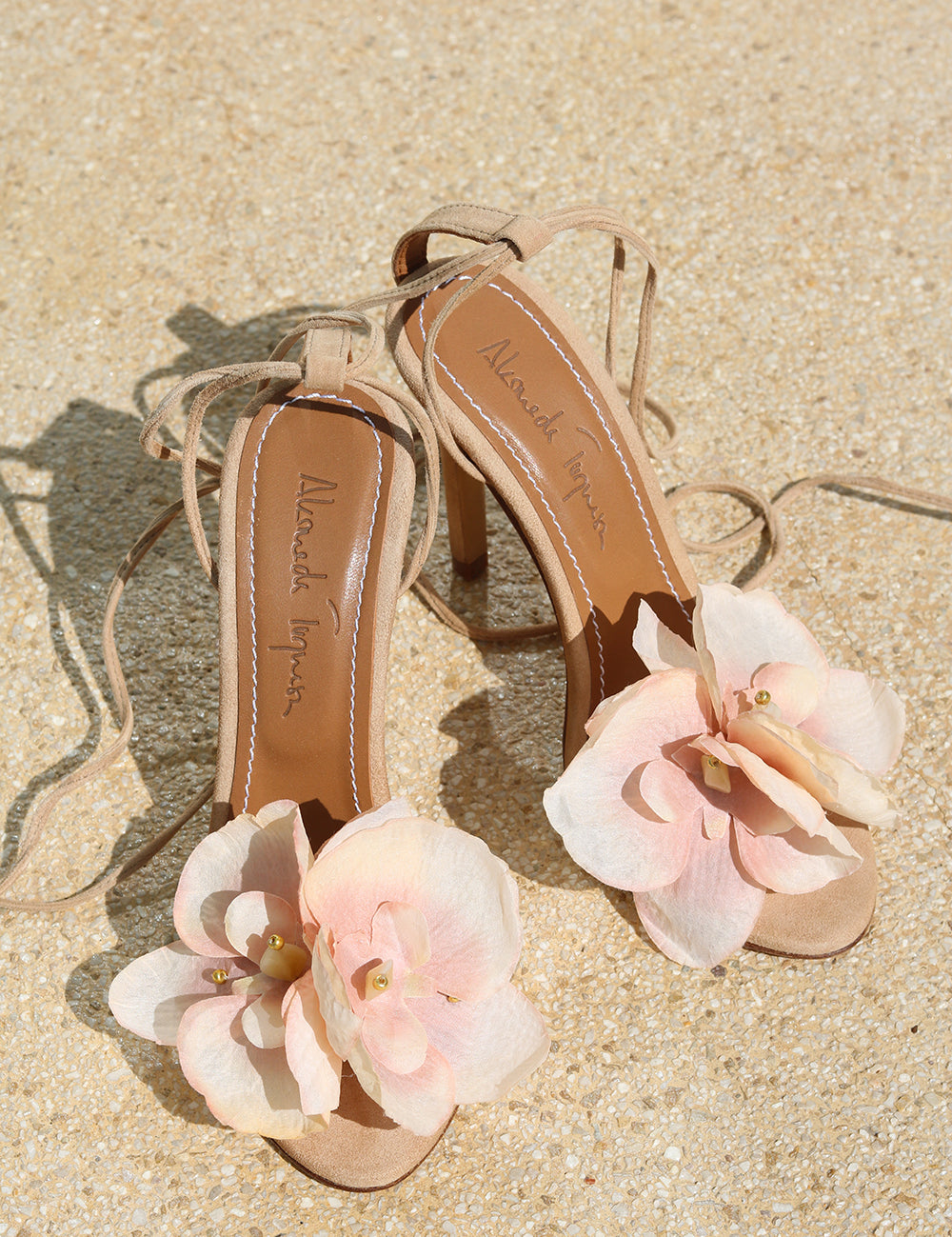 Clarissa nude suede flower heels flat lay — handcrafted blush pink flower embellishment on nude suede stiletto with lace-up ankle ties, as seen on Bella Hadid, Alameda Turquesa Portugal