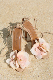 Clarissa nude suede flower heels flat lay — handcrafted blush pink flower embellishment on nude suede stiletto with lace-up ankle ties, as seen on Bella Hadid, Alameda Turquesa Portugal
