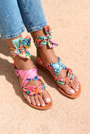 Coralia sandals front view — hand-printed multicolour fabric flat sandals with orange starfish embellishment and wrap ankle ties, worn on body with jeans, handcrafted in Portugal by Alameda Turquesa