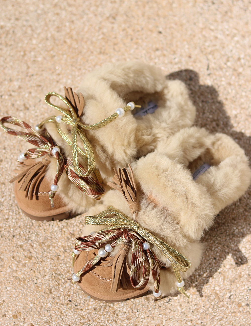 Lola Festive Edition shearling loafers — caramel suede with gold metallic laces, pearl detail and leather tassels, handcrafted in Portugal by Alameda Turquesa