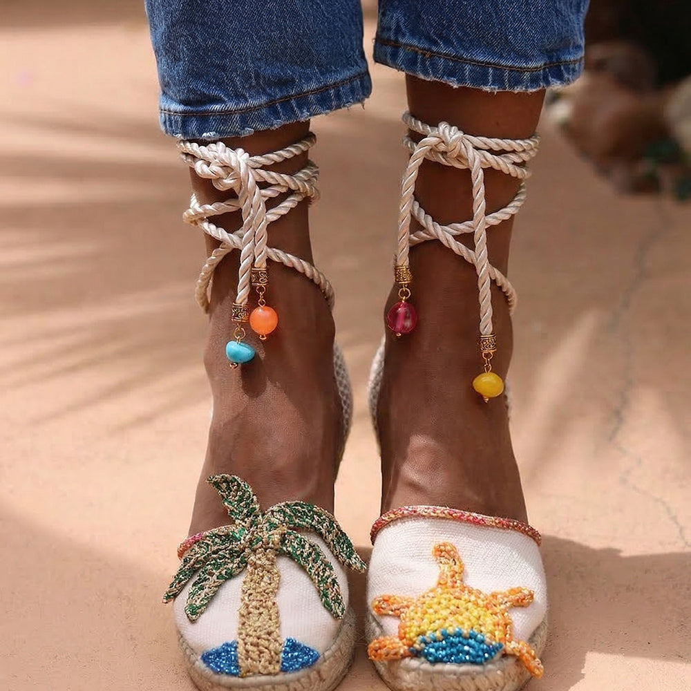 Sunrise wedge espadrilles — hand-embroidered palm tree and sun motifs with silk rope ankle ties and multicolour beaded charms, handcrafted in Portugal by Alameda Turquesa