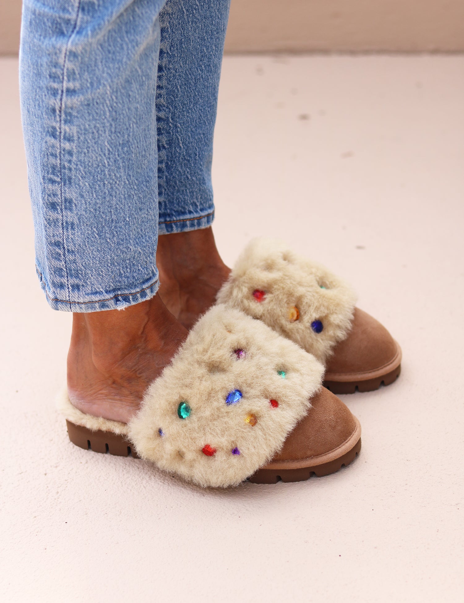 Jasmine flat shearling mule being worn — cream shearling with multicoloured gemstone embellishments, made in Portugal by Alameda Turquesa