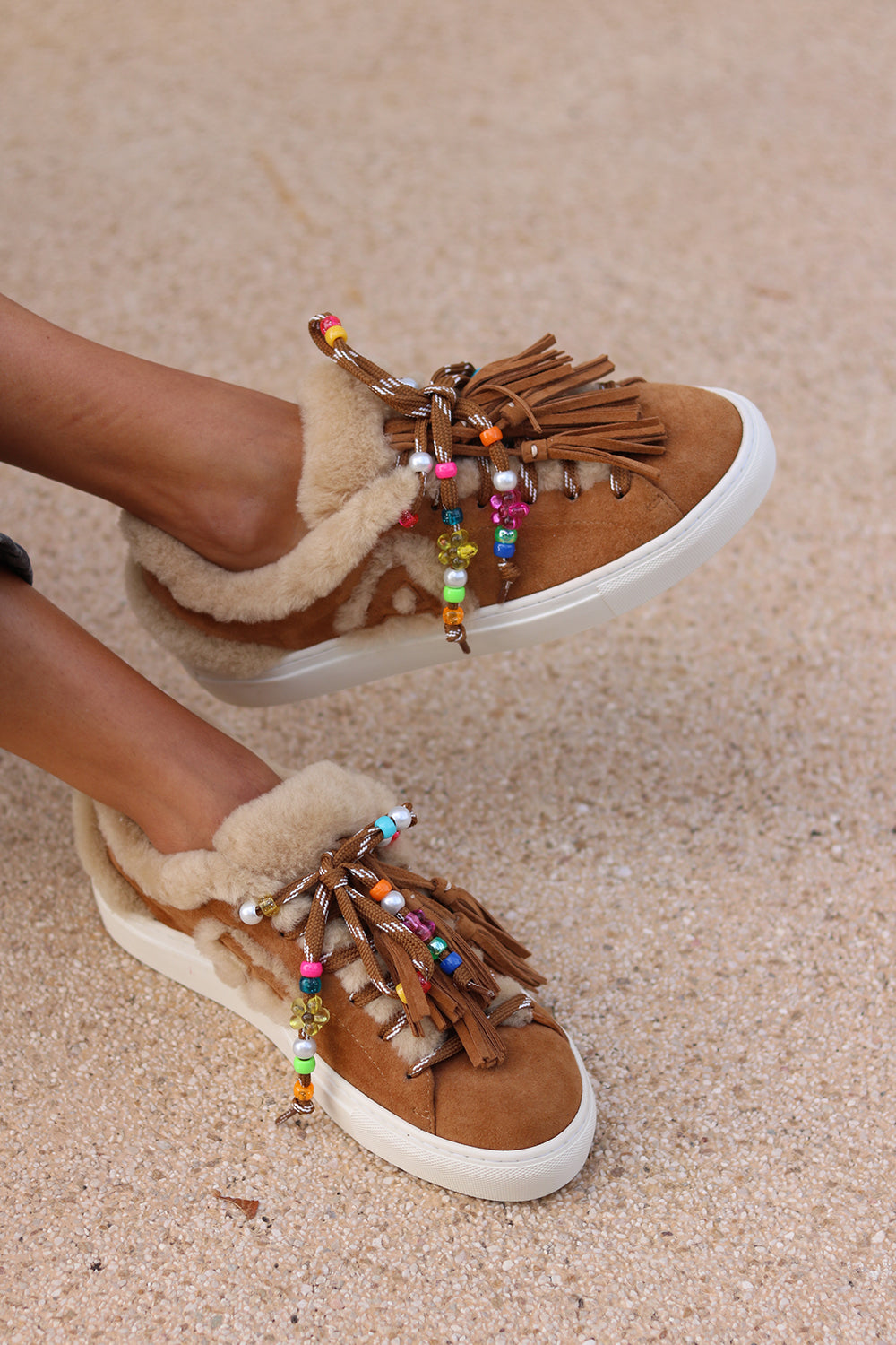 Front view of Zoe caramel suede sneakers by Alameda Turquesa featuring colourful beaded laces, suede tassels and cream shearling