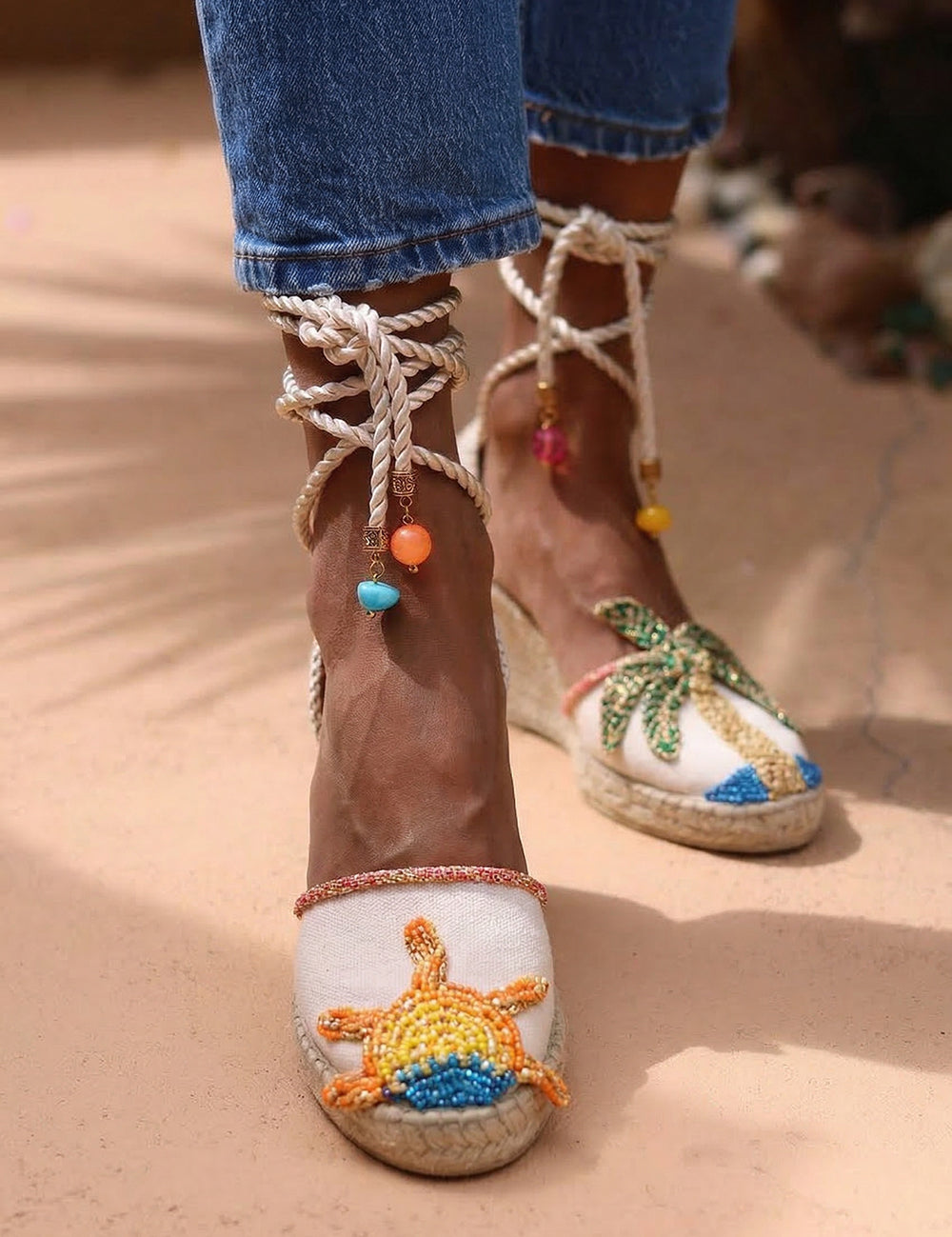 Sunrise wedge espadrilles close up — hand-embroidered sun motif detail with silk rope ankle ties and multicolour beaded charms, handcrafted in Portugal by Alameda Turquesa