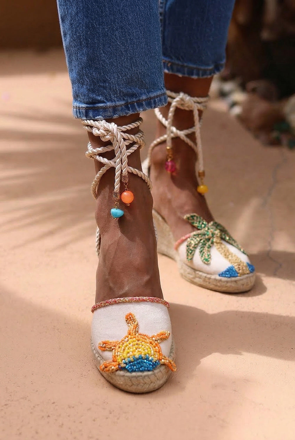 Sunrise wedge espadrilles close up — hand-embroidered sun motif detail with silk rope ankle ties and multicolour beaded charms, handcrafted in Portugal by Alameda Turquesa