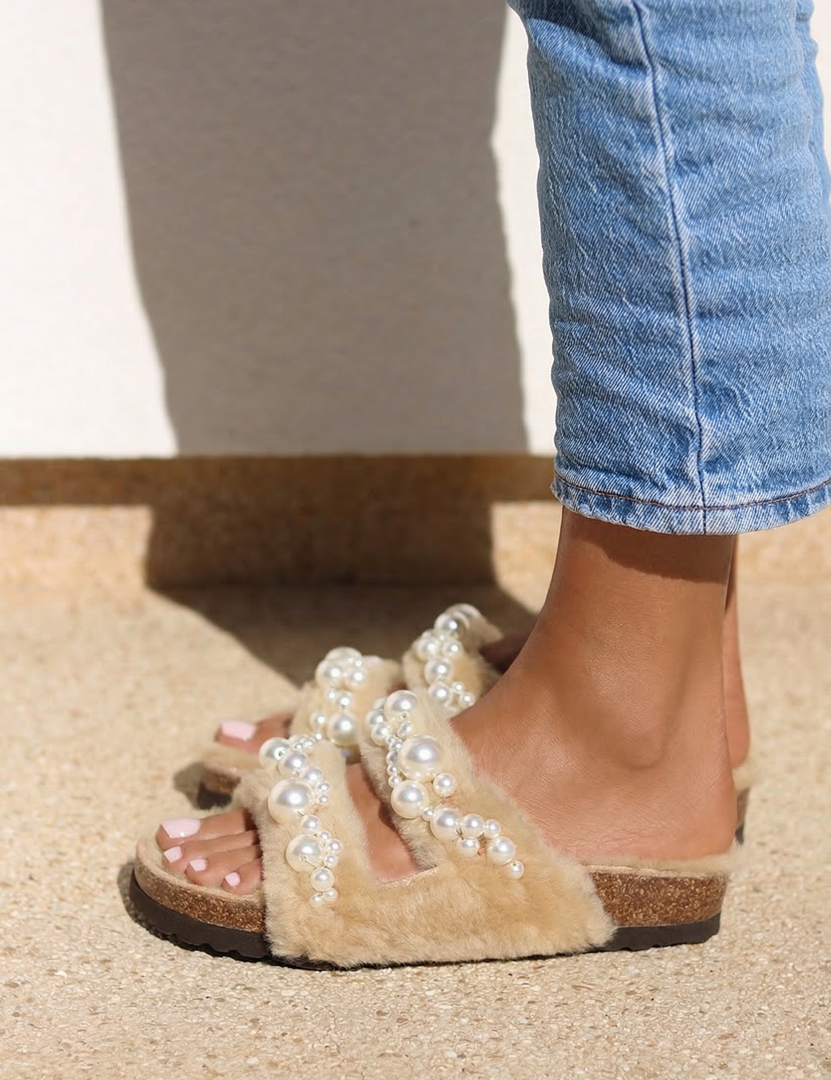Alameda Turquesa Mimi Pearls shearling sandals with pearl embellishments, styled with jeans — as seen in Emily in Paris
