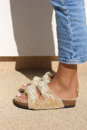 Alameda Turquesa Mimi Pearls shearling sandals with pearl embellishments, styled with jeans — as seen in Emily in Paris