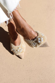 Bella shearling mules top view — cream shearling pointed-toe stiletto mules with hand-applied pearl cluster embellishments, worn on body with white dress, handcrafted in Portugal by Alameda Turquesa