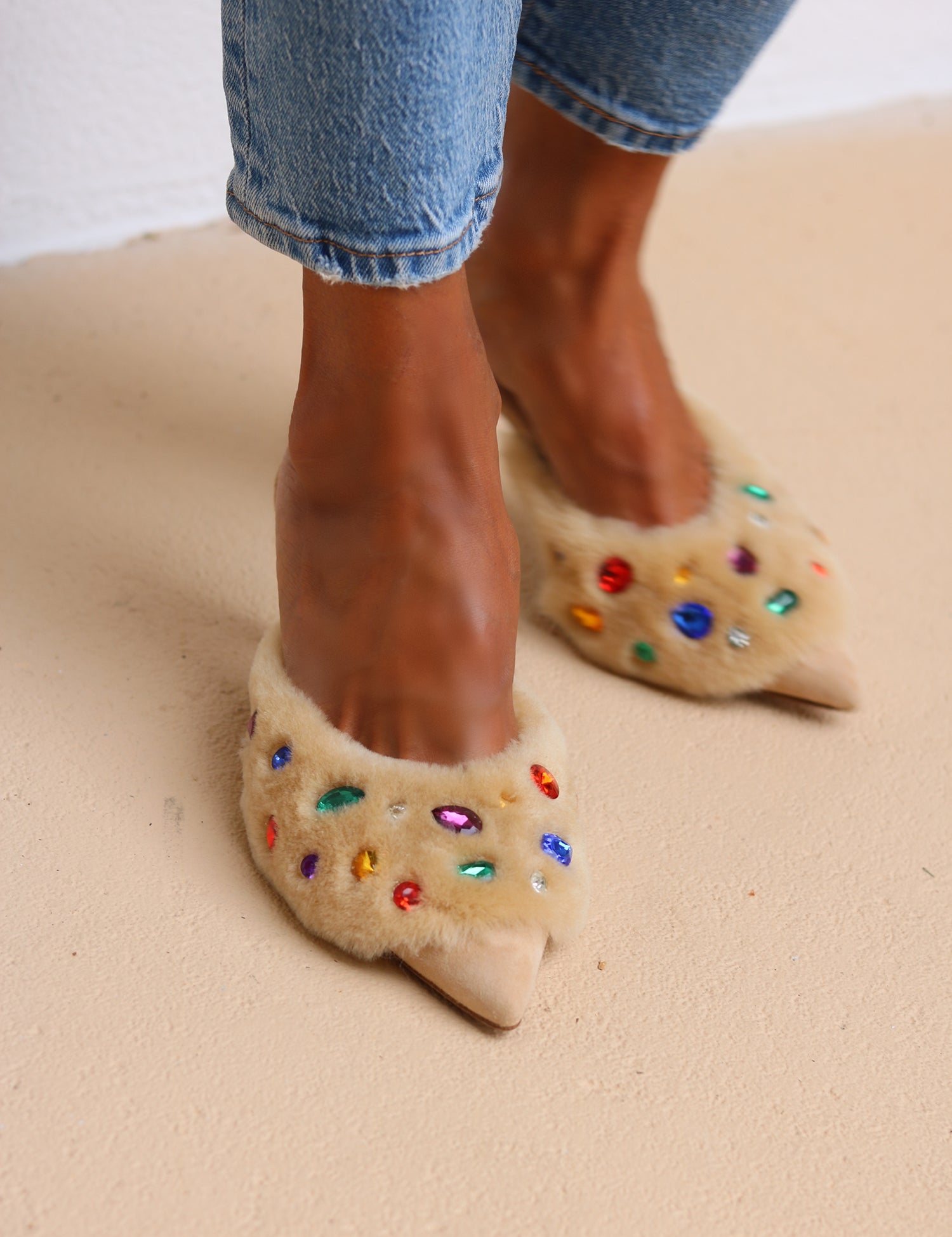 Jasmine Cream shearling gem mules worn with denim