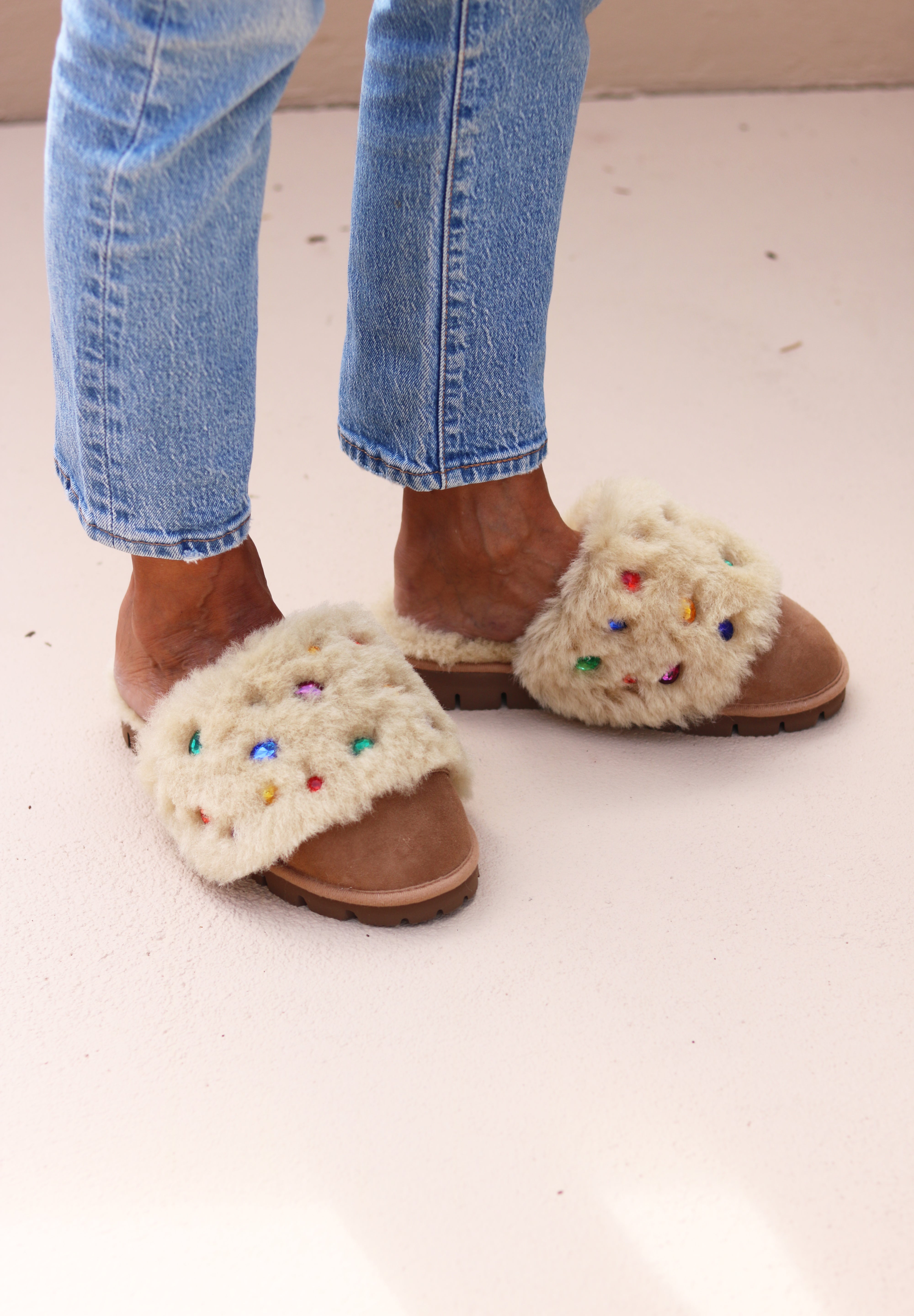 Jasmine flat shearling mule being worn, front view — cream shearling with multicoloured gemstone embellishments, made in Portugal by Alameda Turquesa