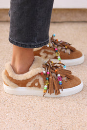 Alameda Turquesa Zoe shearling sneakers in caramel suede with cream shearling, colourful beads and oversized tassels, side view