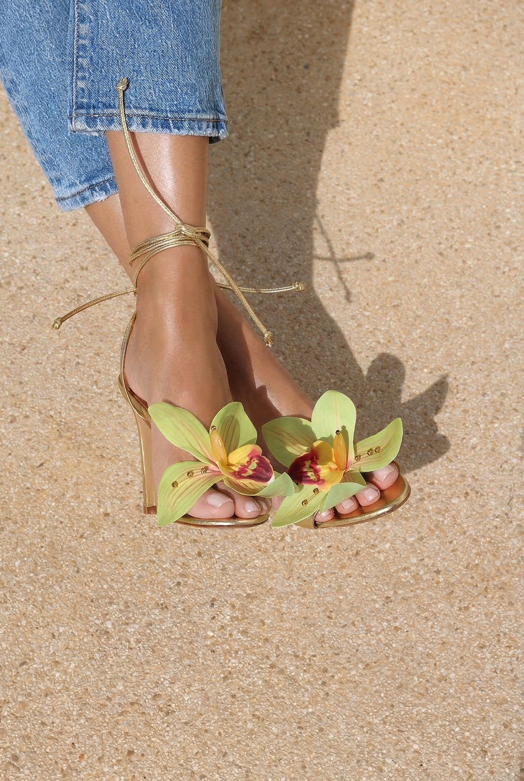 Prudence Gold flower heels side view — handcrafted orchid toe embellishment on slender gold stiletto with lace-up ankle ties, Alameda Turquesa Portugal