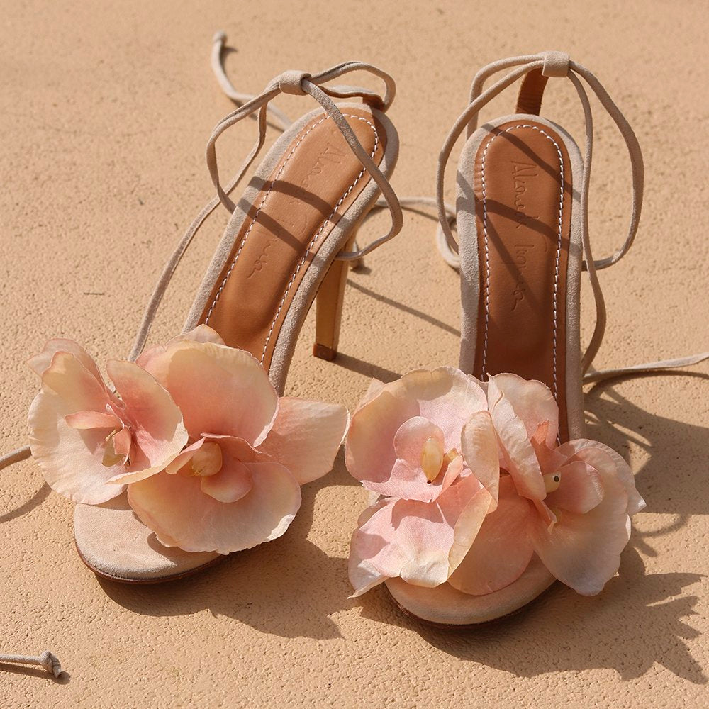 Clarissa Flower Heels – Suede heels with soft pink flower embellishments, showcasing elegant design and luxury craftsmanship