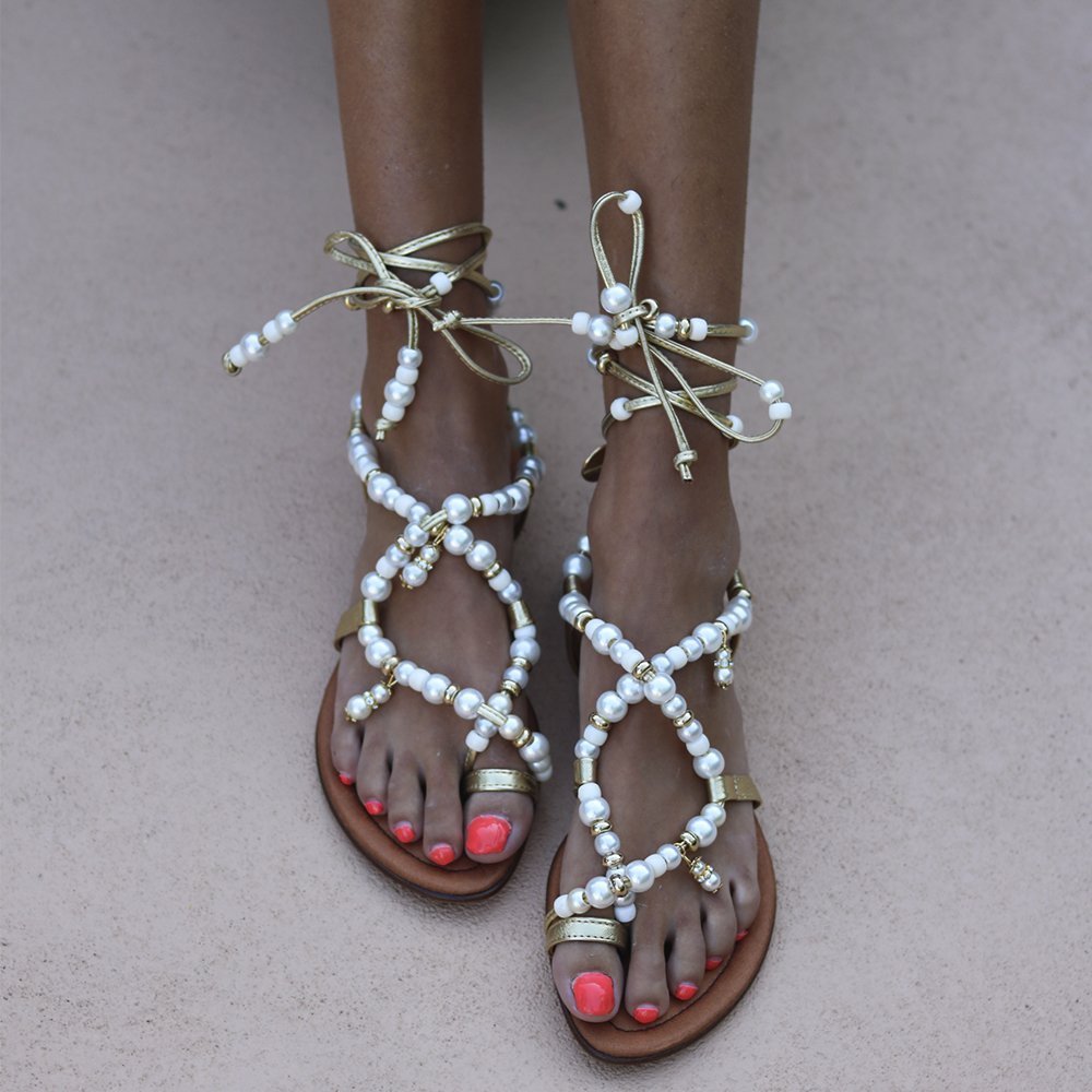 Luz beaded sandals front view — gold leather flat sandals with hand-applied white pearl straps and lace-up ankle ties, worn on body, handcrafted in Portugal by Alameda Turquesa